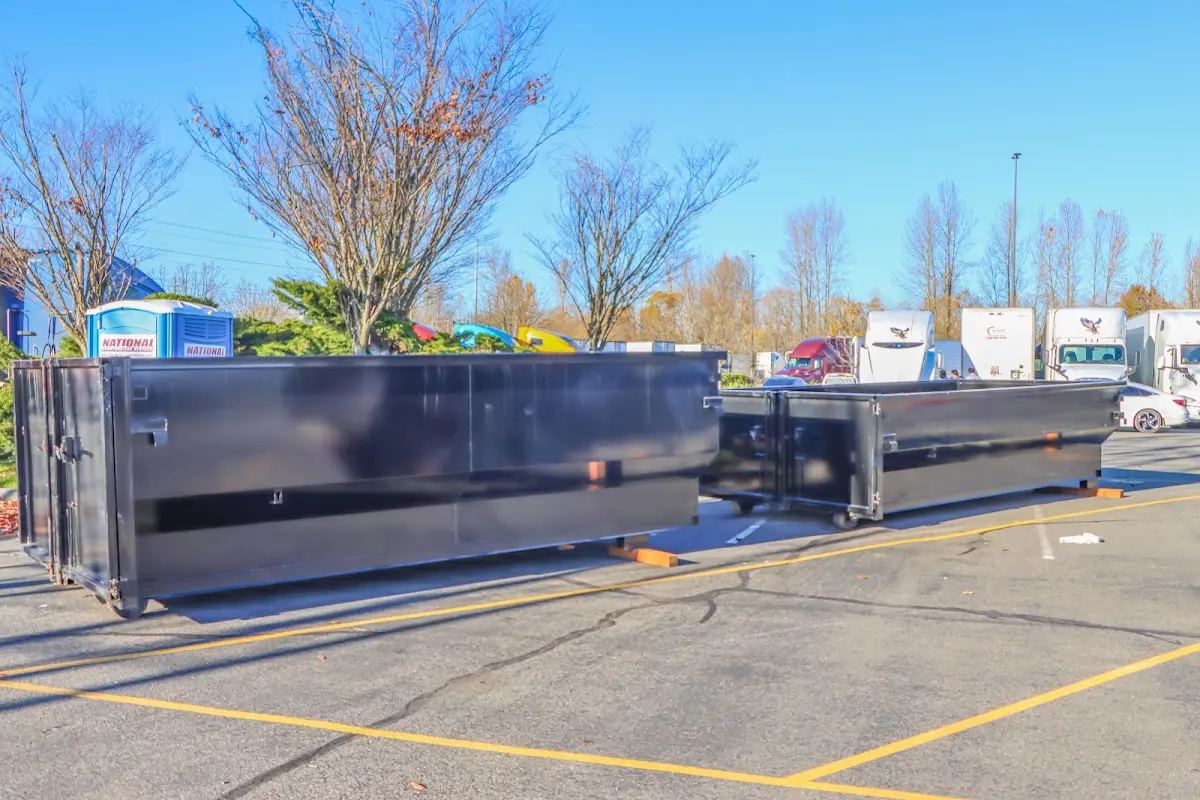 Professional dumpster rental service with roll-off container on residential driveway in Pulaski